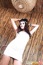 Arms raised wearin bracelets in silver dress