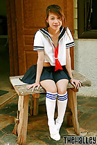  long white socks seated on stool