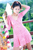 Wearing pink dress holding fan