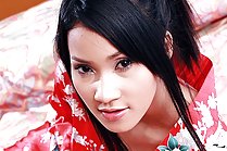 Pretty Memi Paweena stripping red kimono on bed