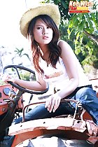 Sitting on tractor wearing hat